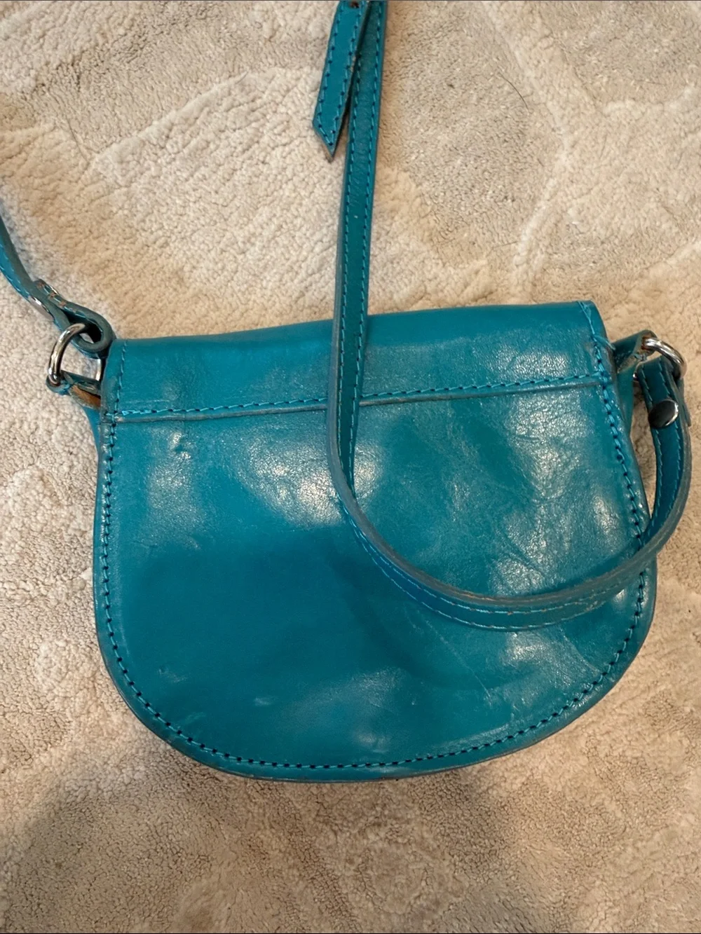 Vintage Florence Made in Italy genuine leather crossbody saddle bag in teal.